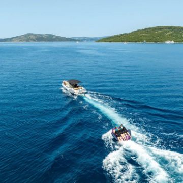 Charter Guests Enjoying The Scout 3 Towable Tube, High-End Water Sports Equipment From Yacht Toys™
