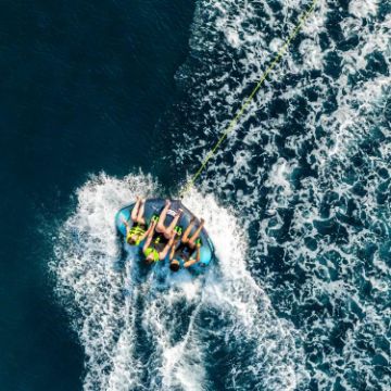 Charter Guests Enjoying The Rumble 3 Towable Tube, High-End Water Sports Equipment From Yacht Toys™