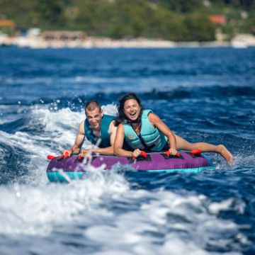 Charter Guests Enjoying The Droplet 2 Towable Tube, High-End Water Sports Equipment From Yacht Toys™