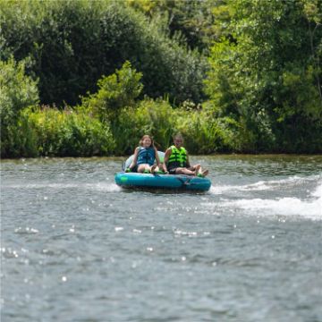 Charter Guests Enjoying The Compound 2 Towable Tube, High-End Water Sports Equipment From Yacht Toys™