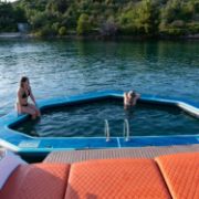 Charter Guests Enjoying The Infinity Pool, High-End Water Sports Equipment From Yacht Toys™