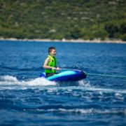 Crew Demonstrating The Compact Footprint And Easy Storage Of The Jobe Sports Shark 1 Towable Tube Towable Inflatable