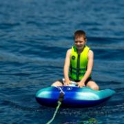 Crew Demonstrating The Compact Footprint And Easy Storage Of The Jobe Sports Kids Neoprene Vest Buoyancy Aid