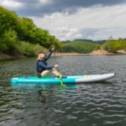 Crew Demonstrating The Compact Footprint And Easy Storage Of The Jobe Sports Aero Tana Hybrid Sup Paddleboard