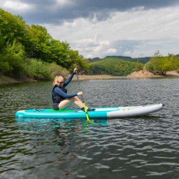 Crew Demonstrating The Compact Footprint And Easy Storage Of The Jobe Sports Aero Tana Hybrid Sup Paddleboard